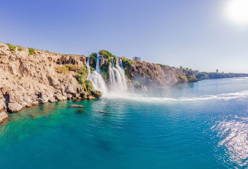 lower duden falls drop off a rocky cliff falling from about 40 m into the mediterranean sea in amazing water clouds. tourism and travel destination photo in antalya, turkey. turkiye.