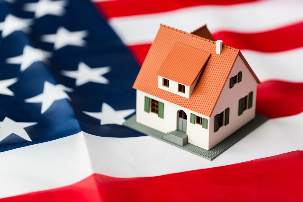 close up of house model on american flag
