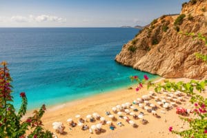 kaputas beach with blue water on the coast of antalya region in turkey with sun umbrellas on the beach