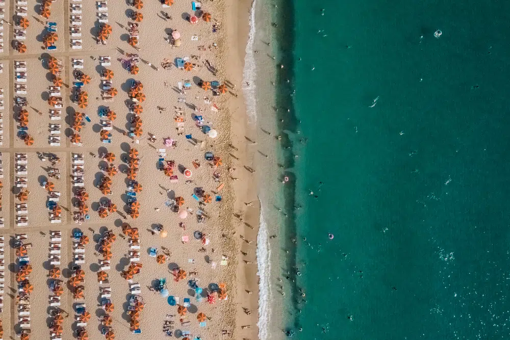 aerial view of people resting on the beach near the sea