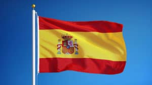 spain flag waving against clean blue sky, close up, isolated wit