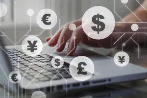 foreign currency exchange concept, forex trading. dollar, euro, pound and yen signs with businessman working on computer on background.