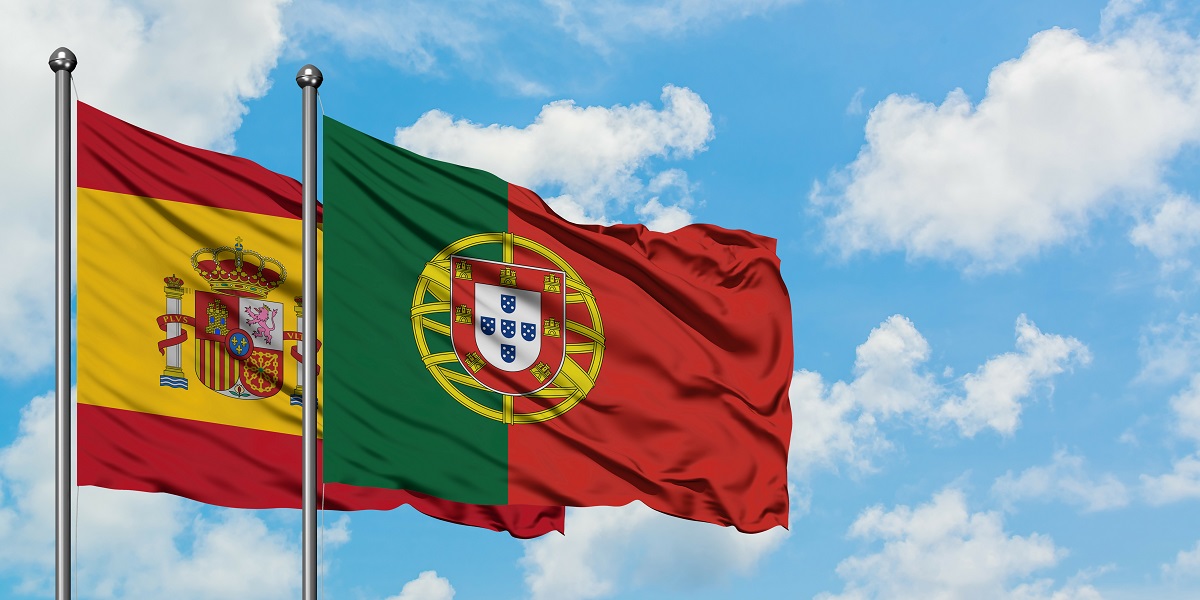 spain and portugal flag waving in the wind against white cloudy