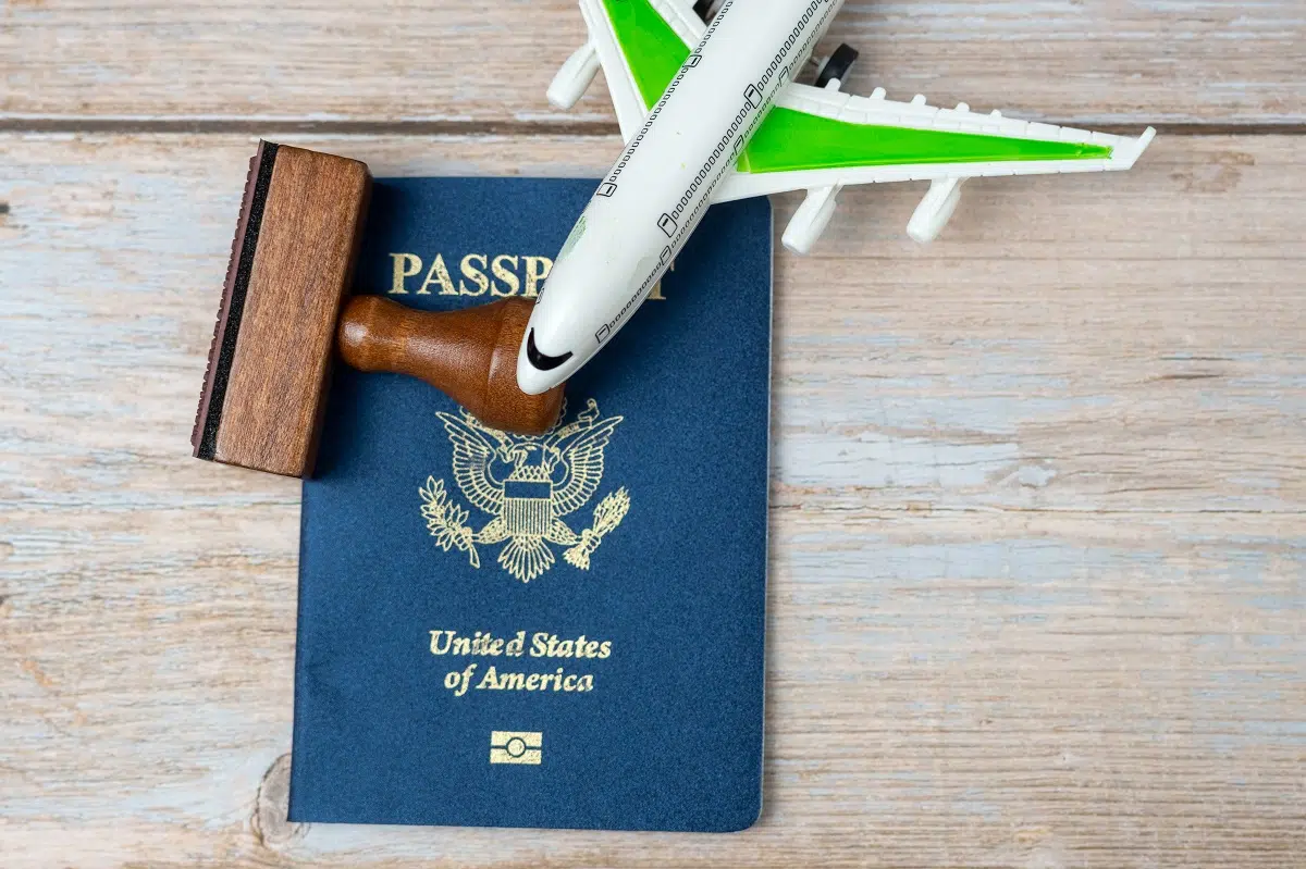 us passport and stamp on wooden background. safe journey with ne