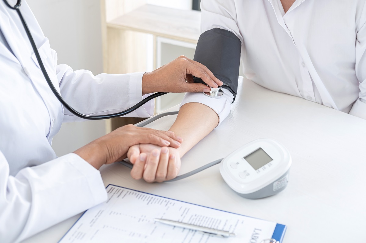 doctor using a measuring blood pressure checking patient with ex