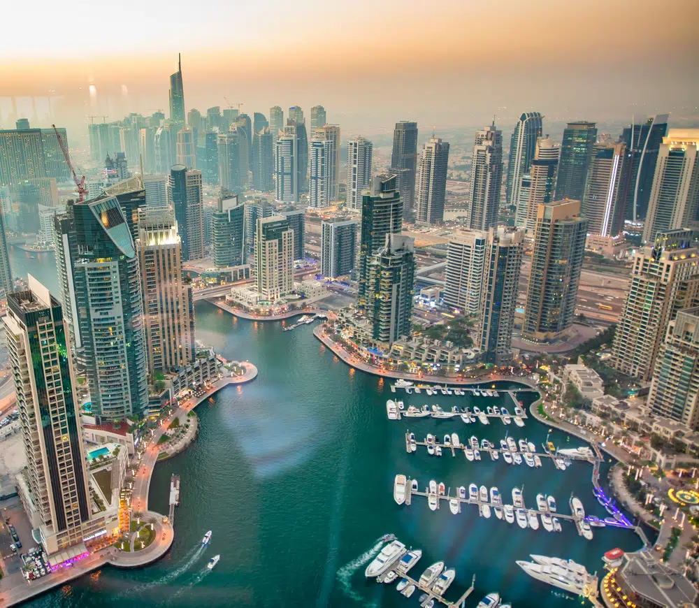 dubai marina creek and skyscrapers at sunset, uae